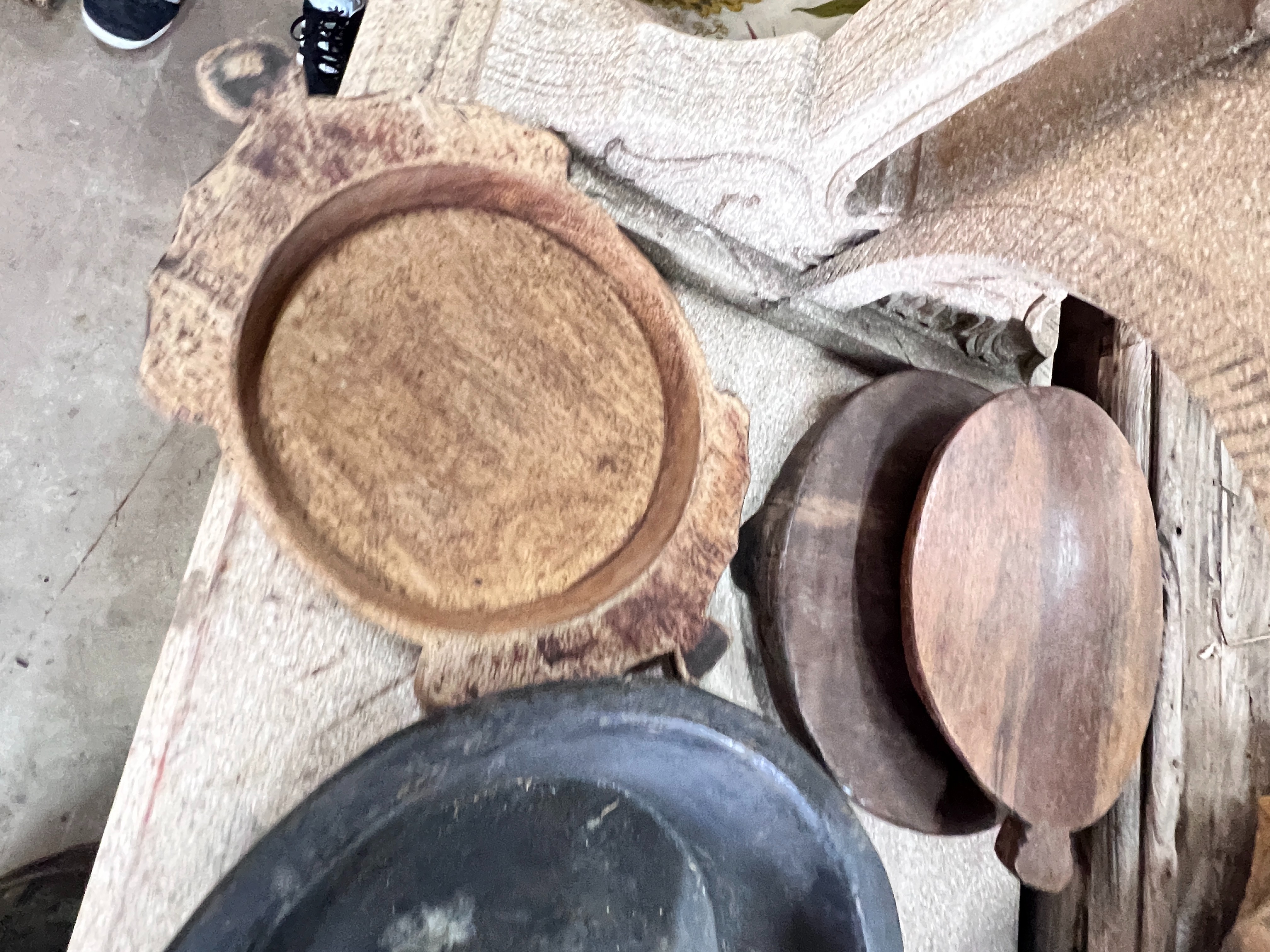 Two wood mazers and five wood trivets, largest diameter 38cm